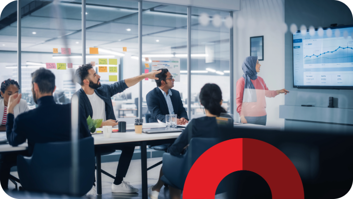 Students working in a seminar room watching a presentation, with a decorative red half circle brand element overlay. Students working in a seminar room watching a presentation, with a decorative red half circle brand element overlay.